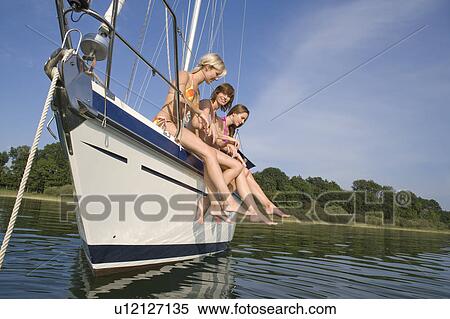 Girls sitting on boat View Large Photo Image Stock Photography - Girls sitting on boat. Fotosearch