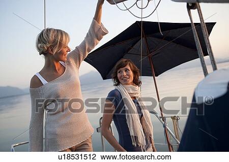 Girls standing on boat View Large Photo Image Stock Image - Girls standing on boat. Fotosearch