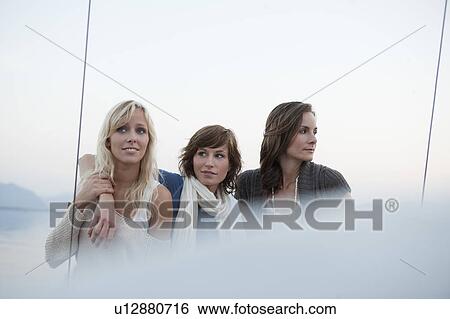 Girls standing on boat View Large Photo Image Stock Photograph - Girls standing on boat. Fotosearch