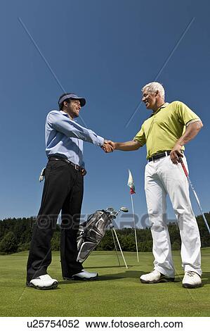 Golfer and caddy shaking hands View Large Photo Image Stock Image - Golfer and caddy shaking hands. Fotosearch