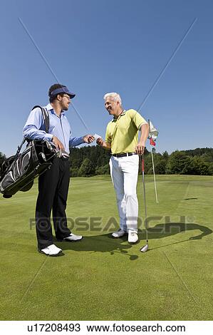 Golfer giving his card to the caddy View Large Photo Image Stock Image - Golfer giving his card to the caddy. Fotosearch