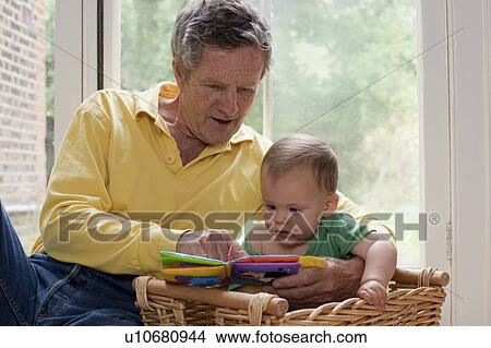 Picture - Grandad reading grandson a story. Fotosearch