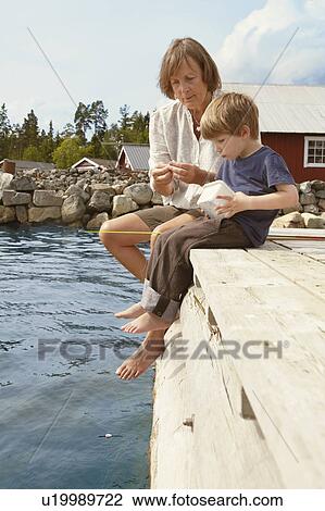 Grandmother and boy fishing from jetty View Large Photo Image Stock Image - Grandmother and boy fishing from jetty. Fotosearch