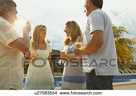 Group of friends having drinks by pool View Large Photo Image Picture - Group of friends having drinks by pool. Fotosearch