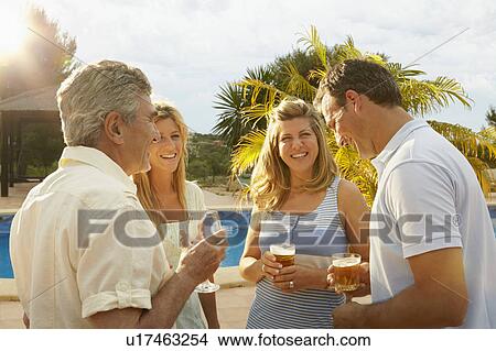 Group of people having a drink by pool View Large Photo Image Picture - Group of people having a drink by pool. Fotosearch