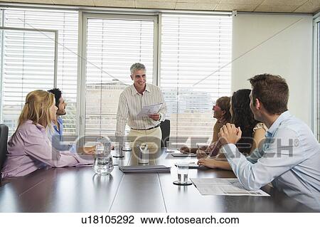Stock Image - Group of people in discussion in meeting. Fotosearch