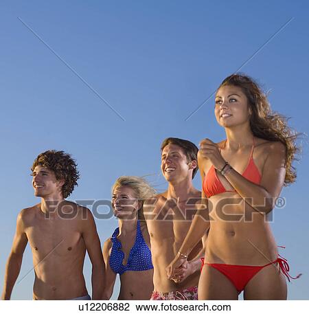Stock Image - Group run in swim suits. Fotosearch