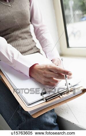 Hand holding clipboard close-up View Large Photo Image Stock Photography - Hand holding clipboard close-up. Fotosearch