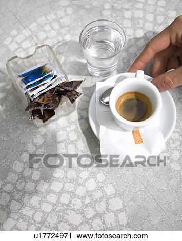 Hand holding cup of Nespresso in cafe View Large Photo Image Stock Image - Hand holding cup of Nespresso in cafe. Fotosearch