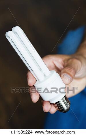Hand holding energy-saving bulb View Large Photo Image Picture - Hand holding energy-saving bulb. Fotosearch