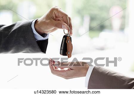 Stock Image - Handing over key. Fotosearch