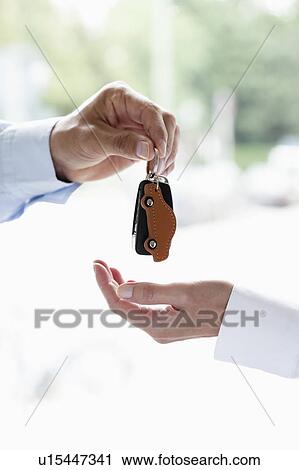 Handing over key View Large Photo Image Stock Image - Handing over key. Fotosearch