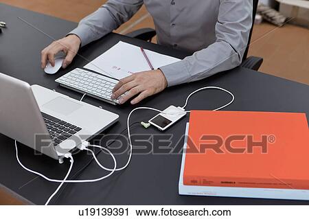 Stock Image - Hands working with keyboard and mouse. Fotosearch