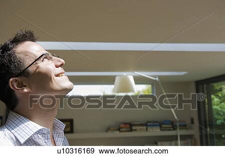Stock Photo - Happy businessman looks to the sky. Fotosearch
