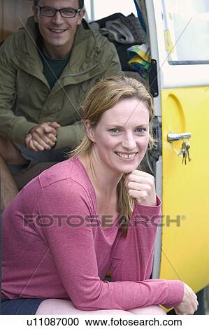 Stock Image - Happy couple in camper van. Fotosearch