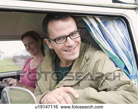 Happy couple sitting in camper van View Large Photo Image Stock Photograph - Happy couple sitting in camper van. Fotosearch