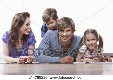 Happy family on rug View Large Photo Image Stock Photograph - Happy family on rug. Fotosearch