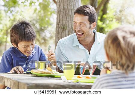 Happy father with 2 boys having a picnic View Large Photo Image Stock Image - Happy father with 2 boys having a picnic. Fotosearch