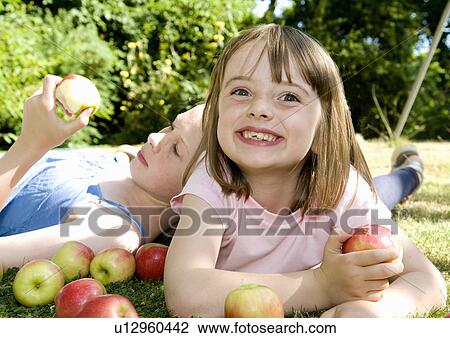Happy girl and friend with apples View Large Photo Image Stock Image - Happy girl and friend with apples. Fotosearch