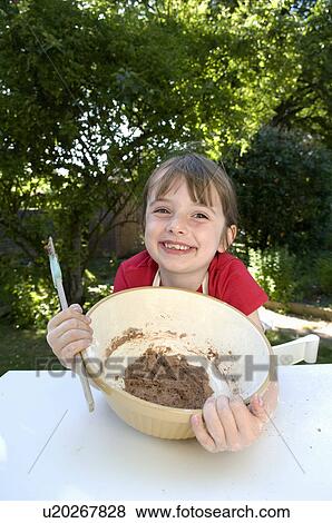 Happy girl with cake mixture View Large Photo Image Stock Photo - Happy girl with cake mixture. Fotosearch