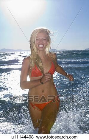 Happy healthy women runs at sea View Large Photo Image Stock Photo - Happy healthy women runs at sea. Fotosearch
