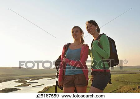 Happy hikers relax after long walk View Large Photo Image Stock Photo - Happy hikers relax after long walk. Fotosearch