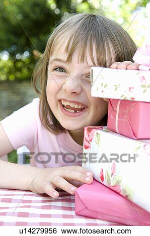 Happy little girl about to open presents View Large Photo Image Stock Photograph - Happy little girl about to open presents. Fotosearch