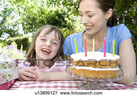 Happy little girl at birthday party View Large Photo Image Stock Photo - Happy little girl at birthday party. Fotosearch