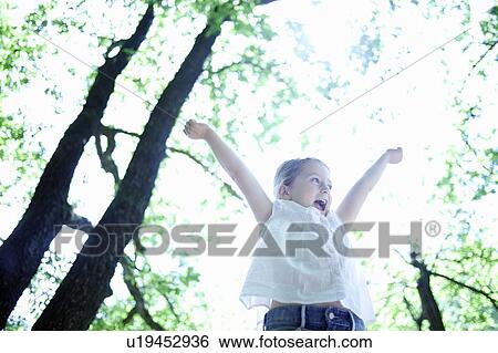 Stock Photograph - Happy little girl in forest. Fotosearch