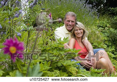 Happy seniors embrace in garden View Large Photo Image Stock Photo - Happy seniors embrace in garden. Fotosearch