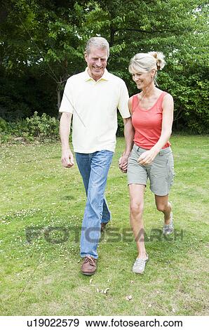 Happy seniors walking View Large Photo Image Stock Photo - Happy seniors walking. Fotosearch