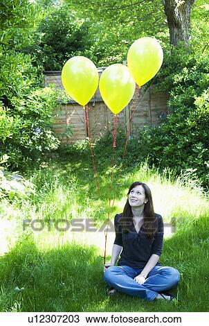 Happy woman with balloons in garden View Large Photo Image Stock Image - Happy woman with balloons in garden. Fotosearch