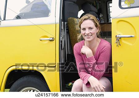 Happy women sits in camper van View Large Photo Image Stock Photograph - Happy women sits in camper van. Fotosearch