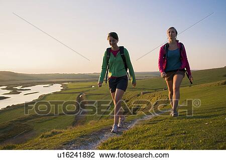 Hikers approach the end of their walk View Large Photo Image Stock Image - Hikers approach the end of their walk. Fotosearch