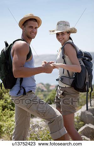 Hikers assisting each other View Large Photo Image Stock Image - Hikers assisting each other. Fotosearch