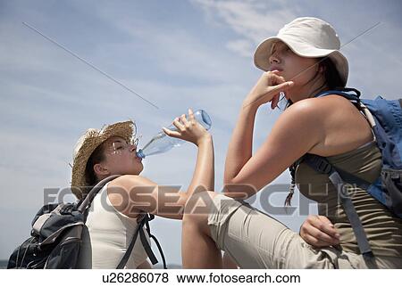 Stock Photo - Hikers drinking water. Fotosearch