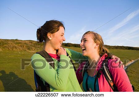 Hikers laugh at end of walk View Large Photo Image Stock Photo - Hikers laugh at end of walk. Fotosearch