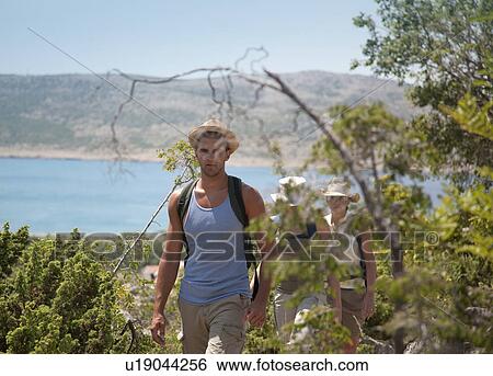 Stock Photograph - Hikers on coastal path. Fotosearch