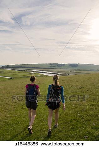 Hikers walking towards river View Large Photo Image Stock Photograph - Hikers walking towards river. Fotosearch