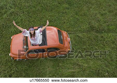Hippy female stretching out of car View Large Photo Image Stock Image - Hippy female stretching out of car. Fotosearch