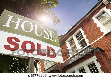 Stock Photograph - House with SOLD notice. Fotosearch
