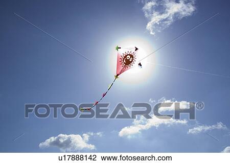 Stock Image - Kite in front of the sun. Fotosearch