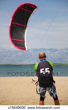 Kitesurfer getting kite ready View Large Photo Image Stock Image - Kitesurfer getting kite ready. Fotosearch