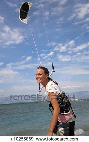 Stock Photo - Kitesurfer getting kite ready. Fotosearch