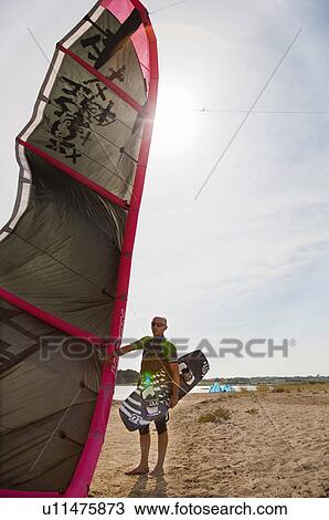 Kitesurfer holding kite and board View Large Photo Image Stock Image - Kitesurfer holding kite and board. Fotosearch