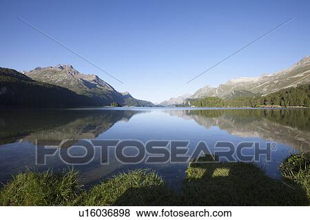 Stock Photo - Lake surrounded by the Alps. Fotosearch