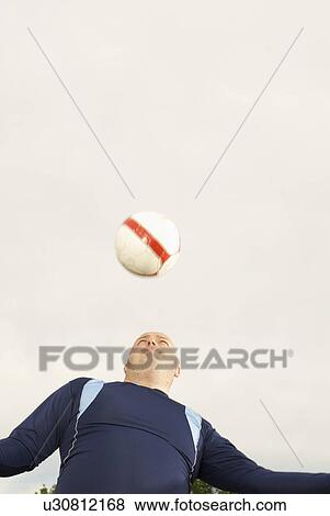 Large footballer heading ball View Large Photo Image Stock Photo - Large footballer heading ball. Fotosearch
