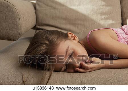 Little Girl dreaming on couch View Large Photo Image Stock Image - Little Girl dreaming on couch. Fotosearch