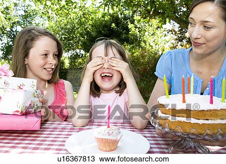 Little girl waiting for cakes and gifts View Large Photo Image Stock Image - Little girl waiting for cakes and gifts. Fotosearch