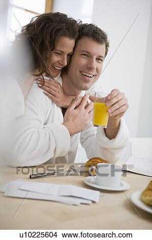 Loving couple having breakfast View Large Photo Image Picture - Loving couple having breakfast. Fotosearch